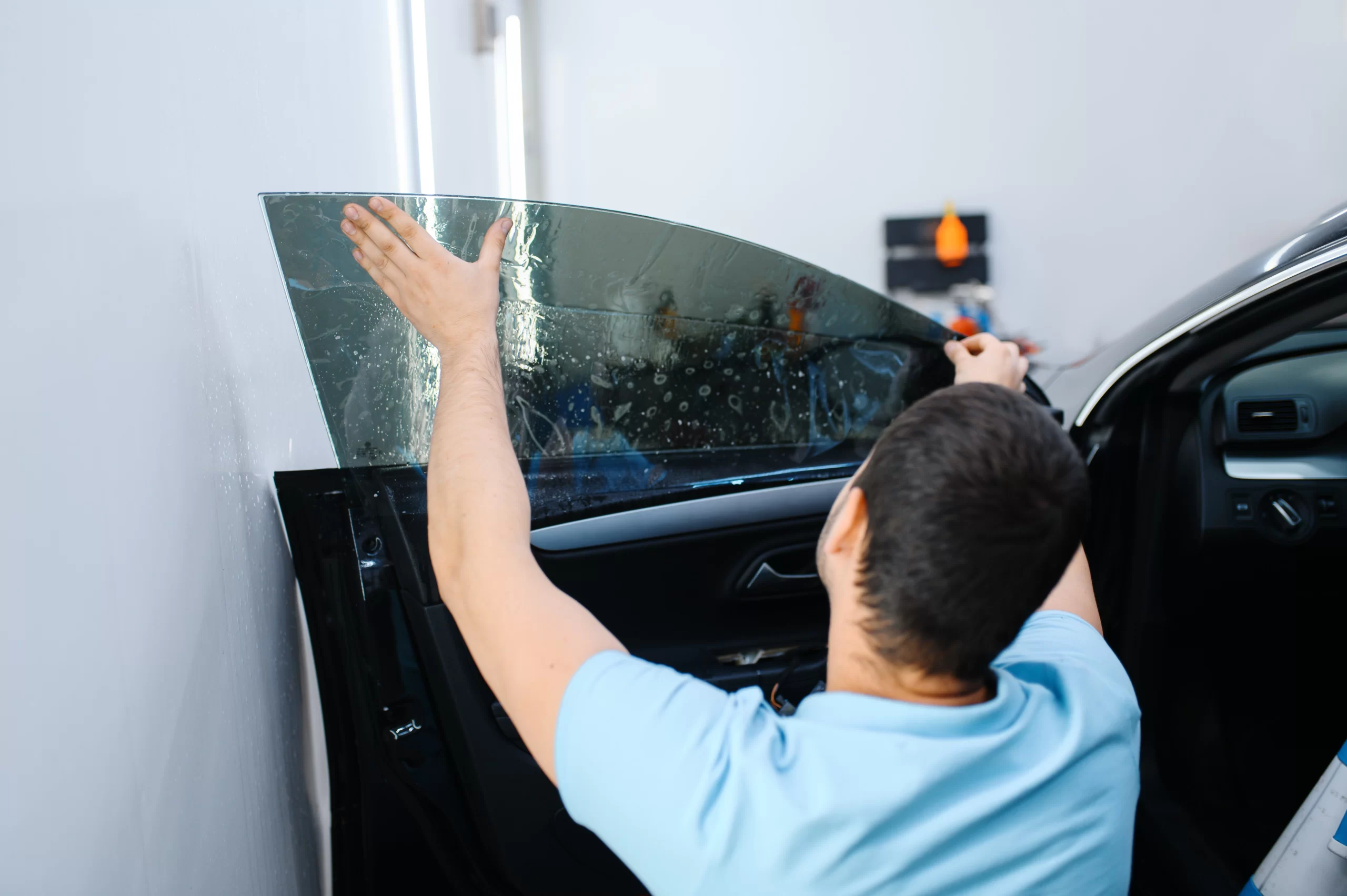 male-worker-tries-on-sheet-of-car-tinting-2024-12-02-10-36-28-utc.webp